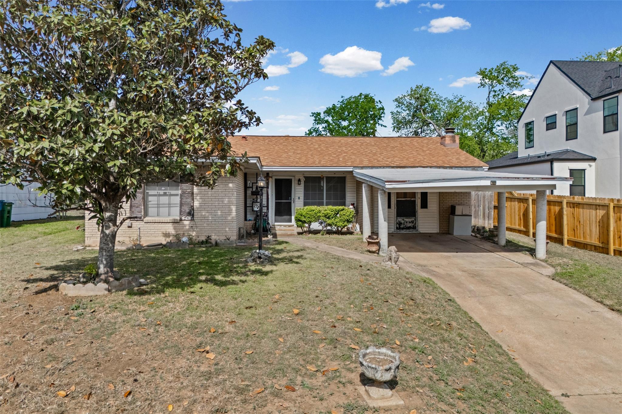View of front facade featuring a carport, brick s