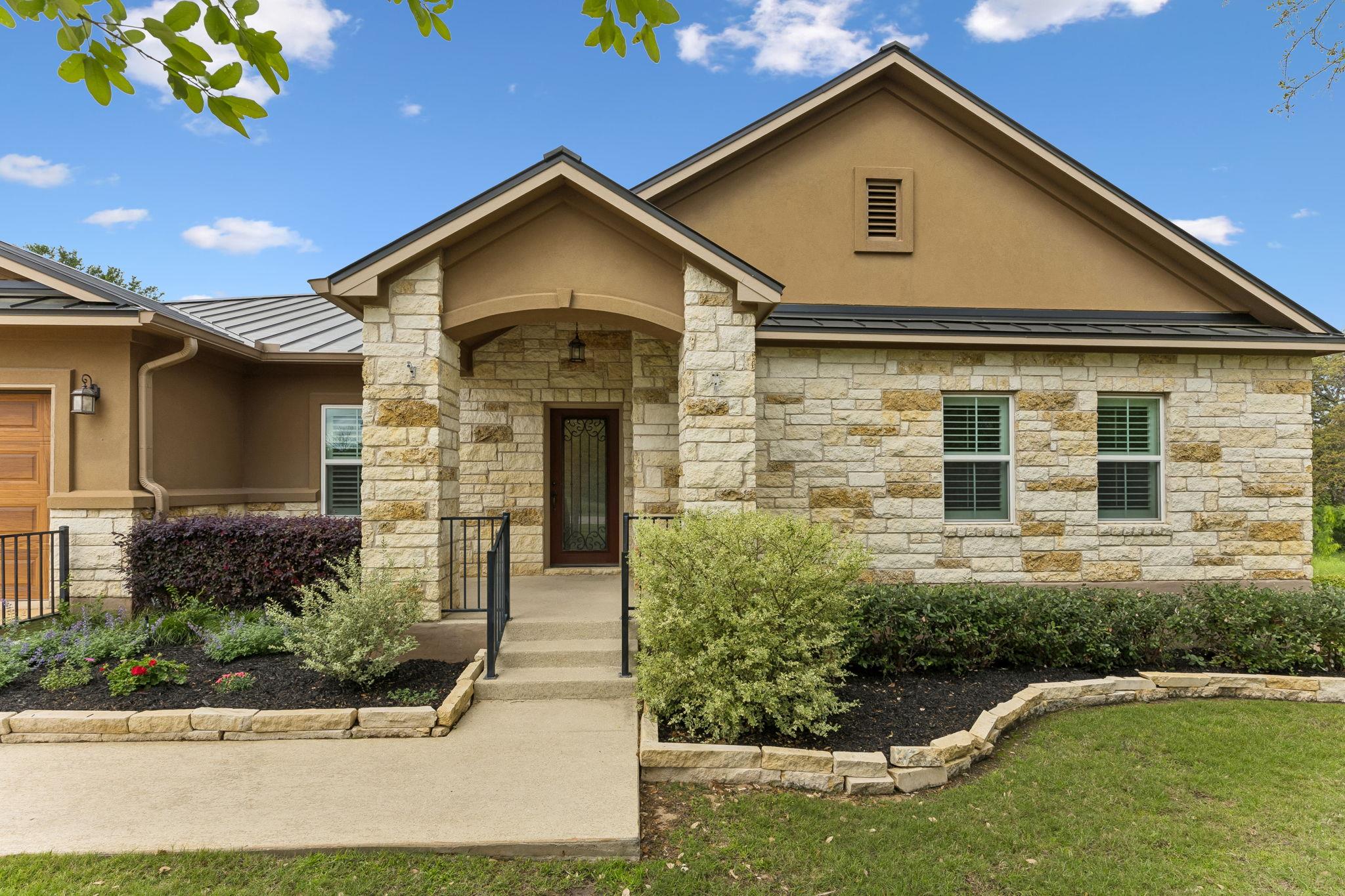 View of front of property featuring stone siding,