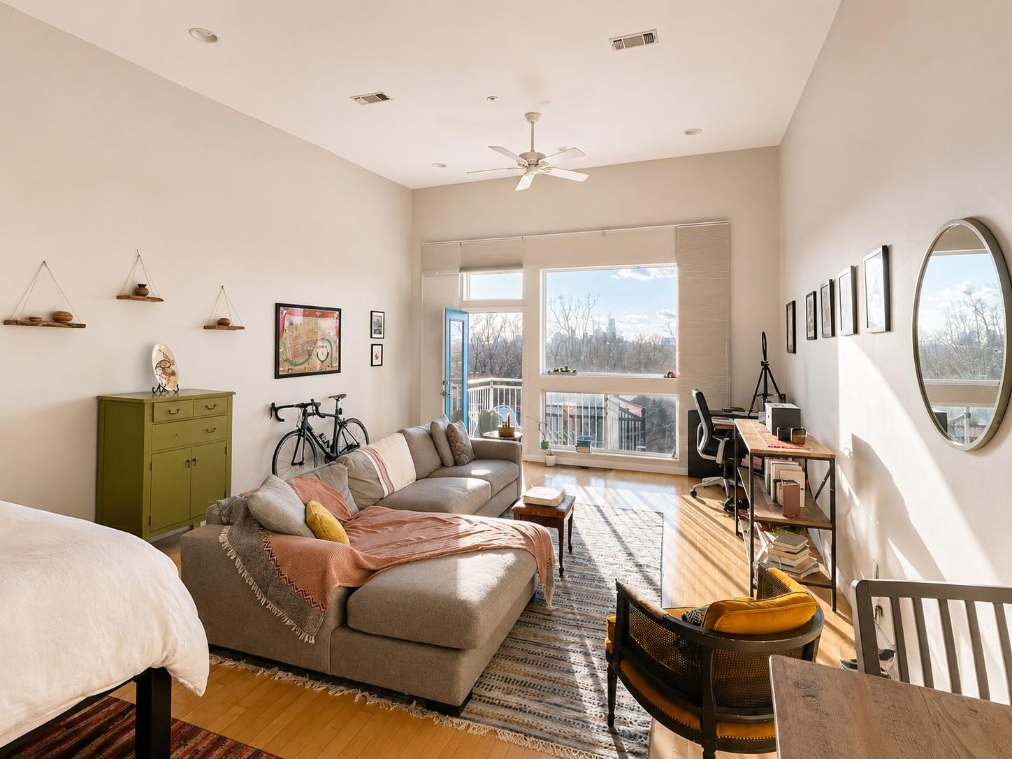 Spacious living area featuring high ceilings, woo
