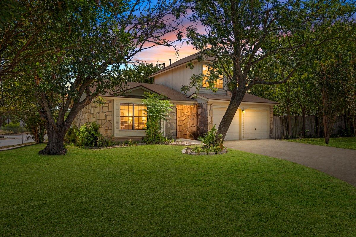 Mature trees frame a charming multi-level residen