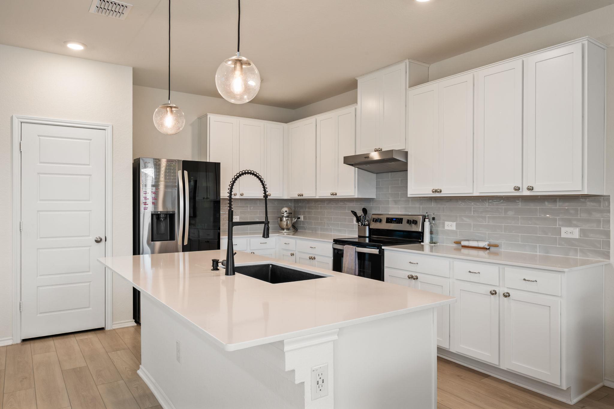 Kitchen with stainless steel appliances, a center