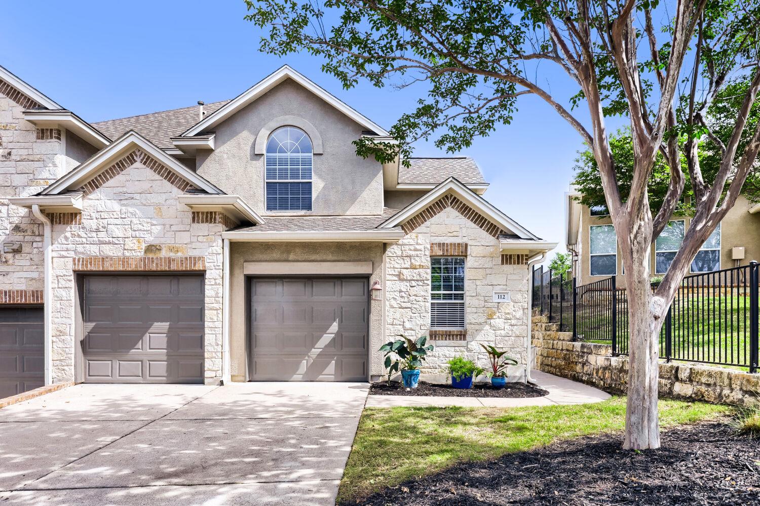 The property features a stucco and stone exterior