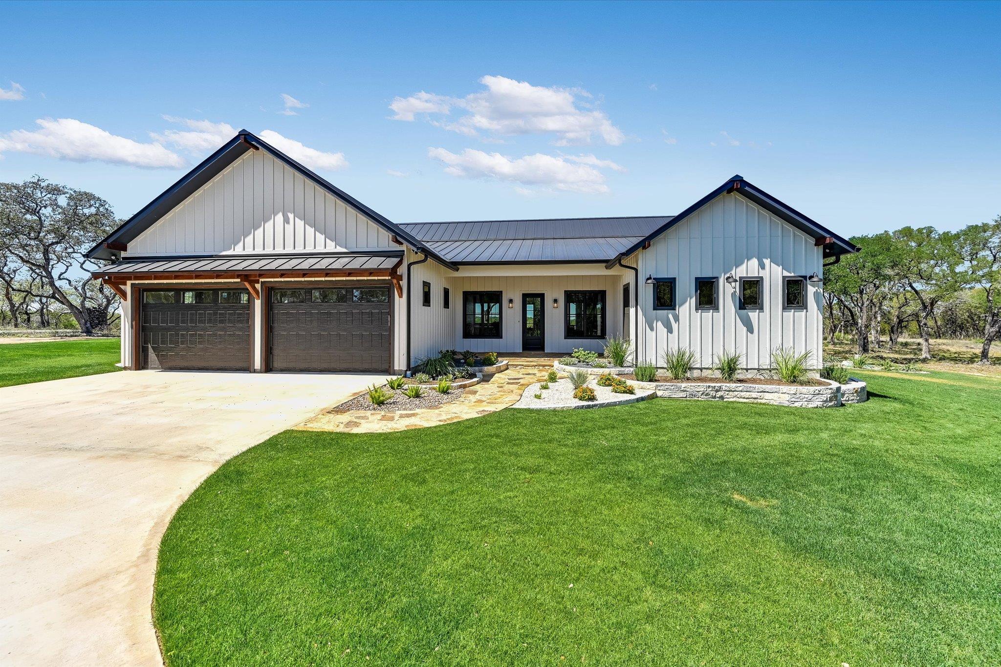 Modern farmhouse featuring a standing seam roof, 