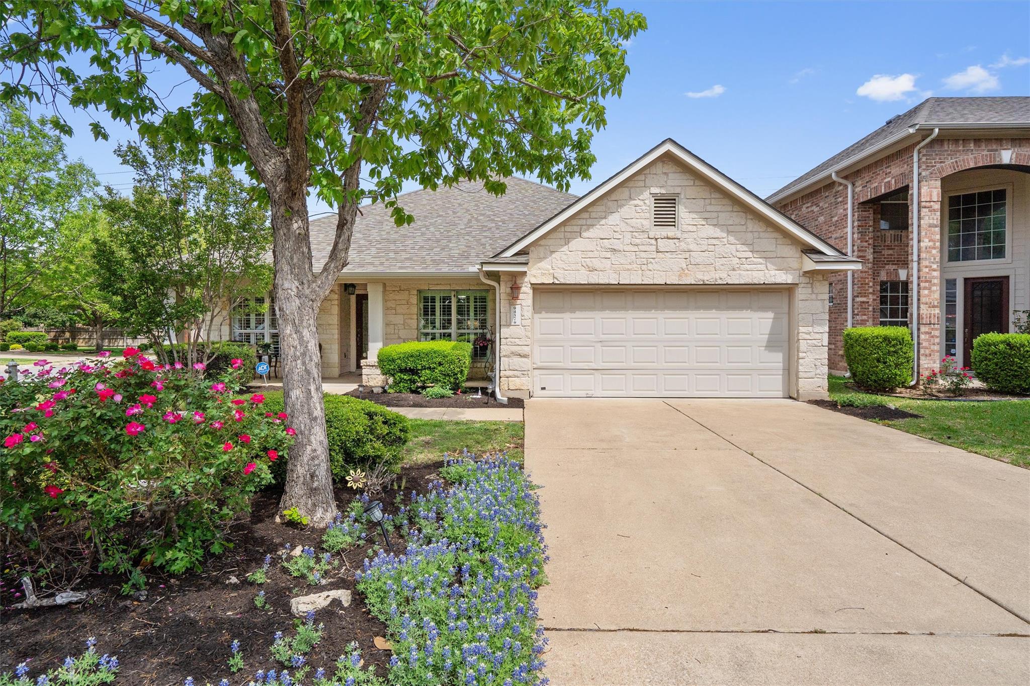 View of front of home with a garage, concrete dri