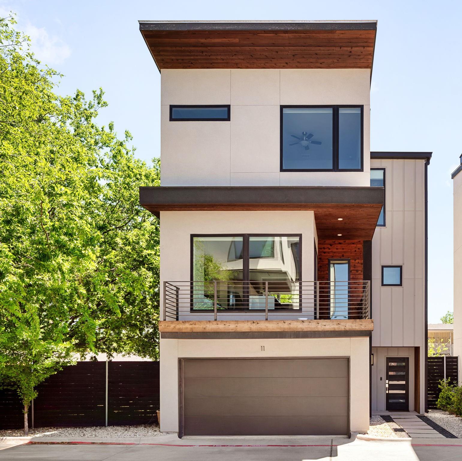 Contemporary home with a balcony, a garage, and d