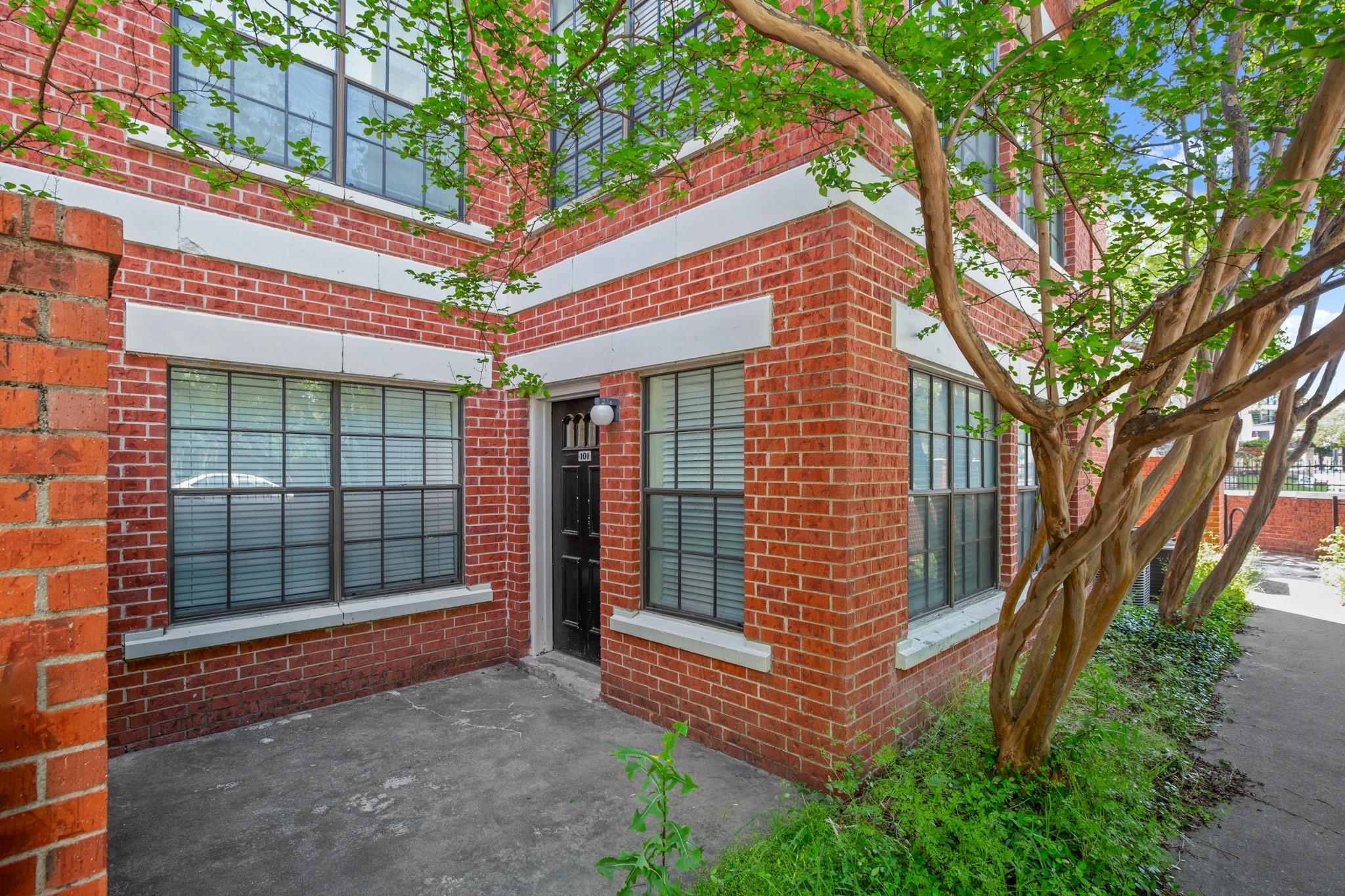 Doorway to property featuring brick siding