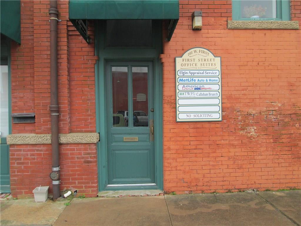 Entrance to property featuring brick siding