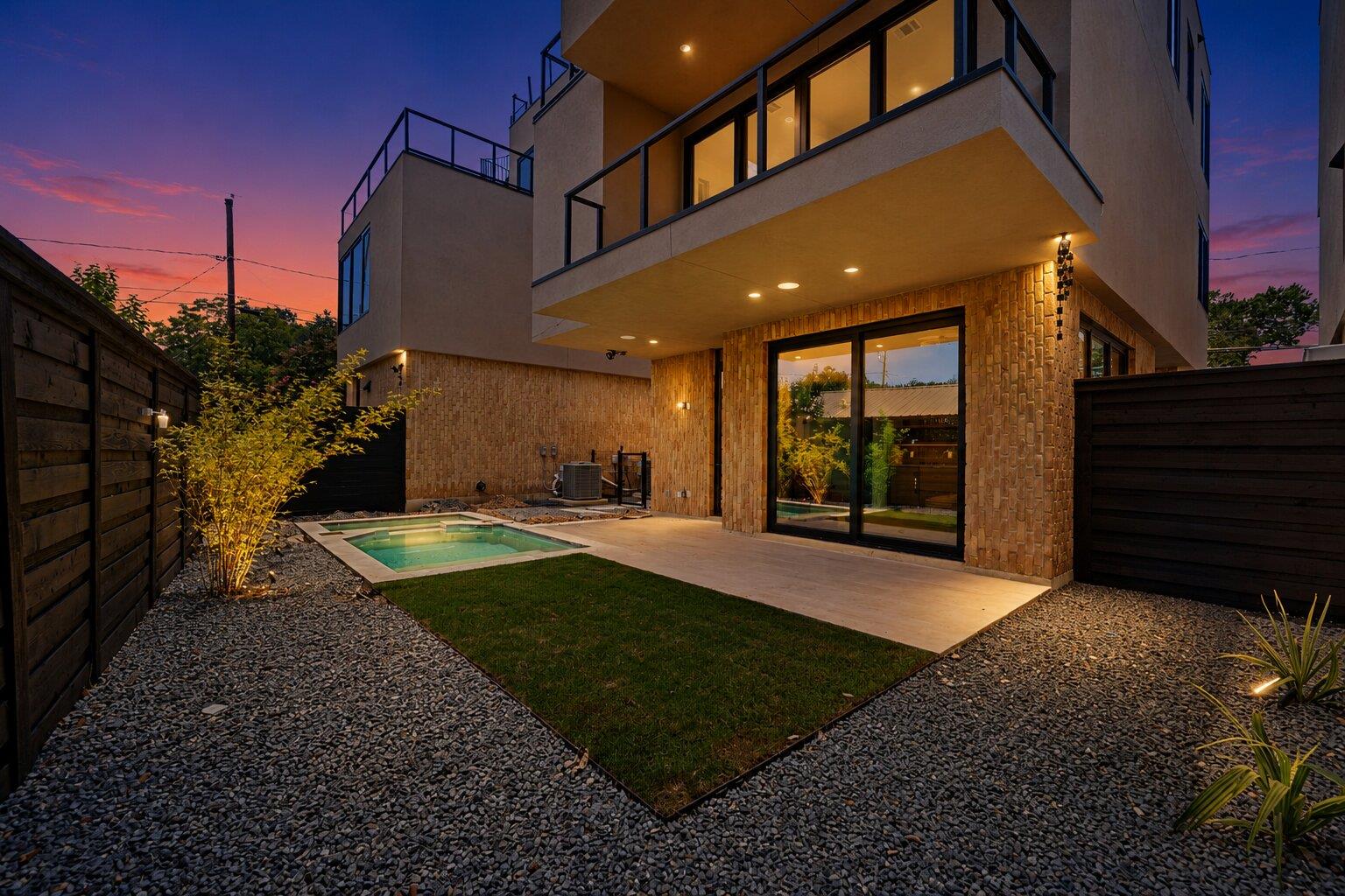 A well-lit patio with a compact pool and manicure