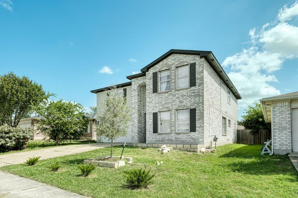 View of front of home featuring brick siding and 