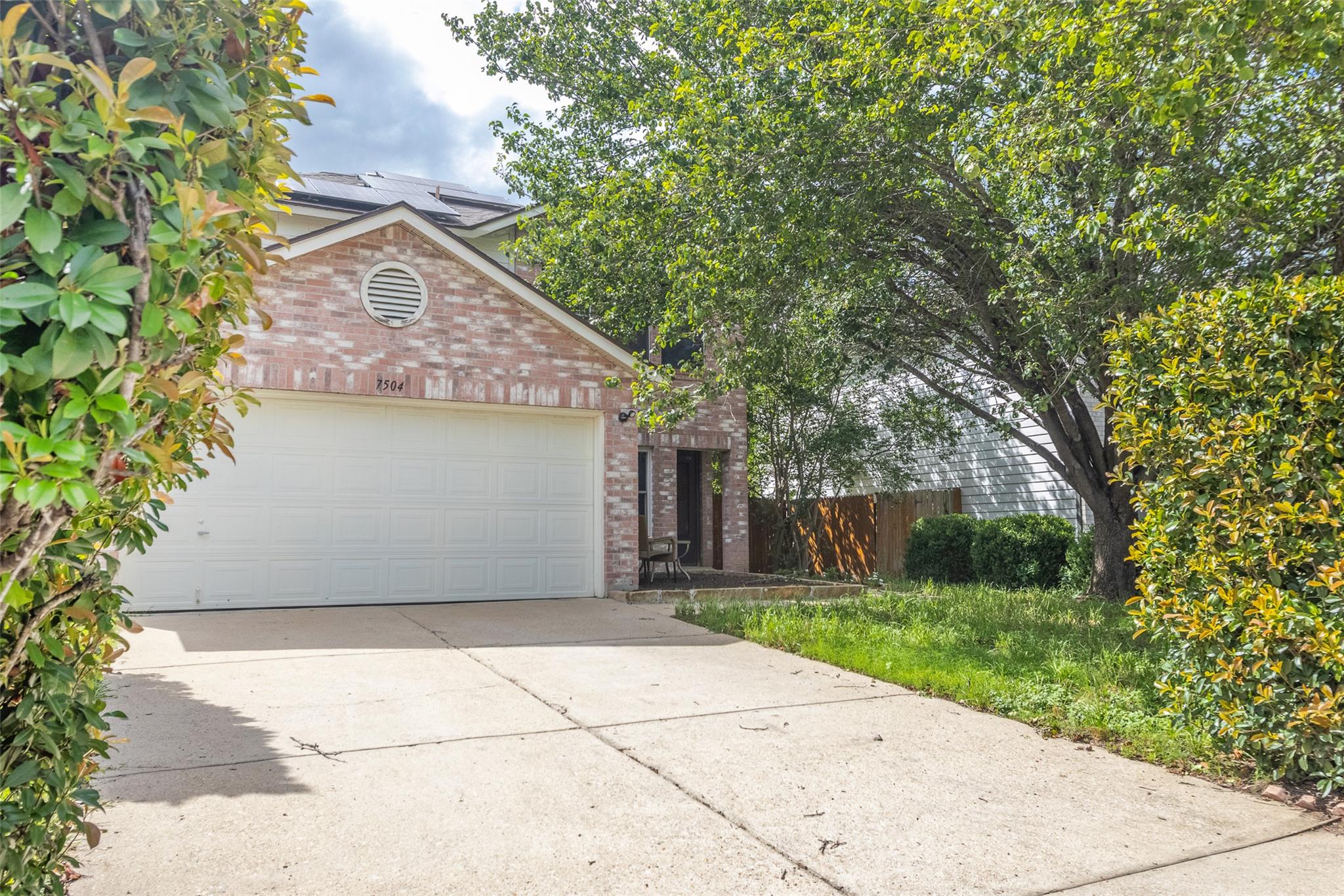 Brick-front residence featuring an attached two-c