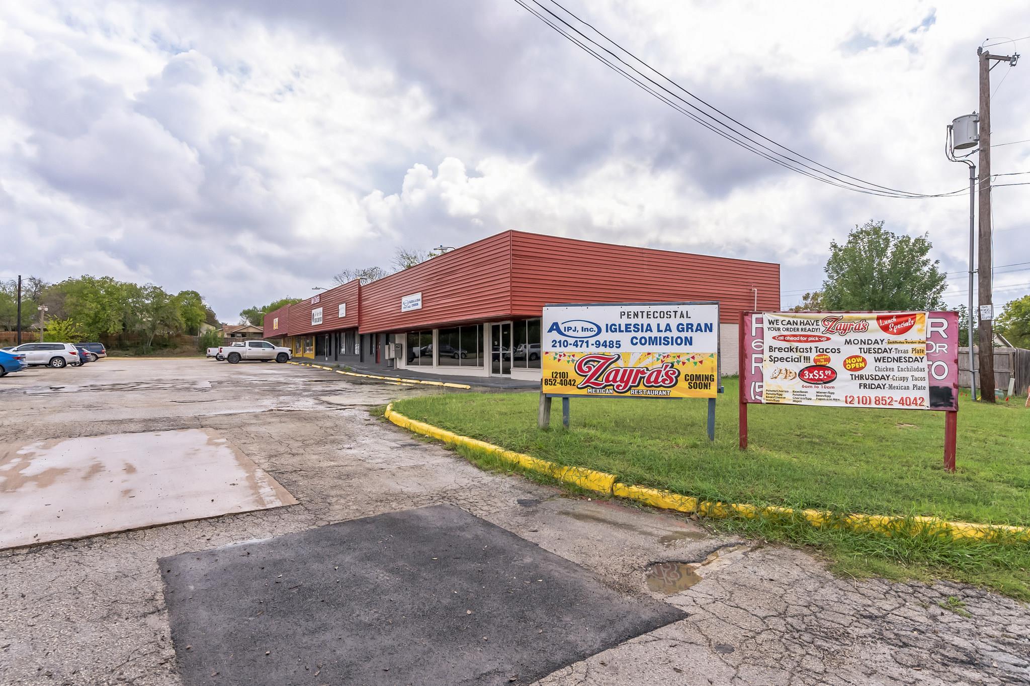 View of commercial property featuring uncovered p