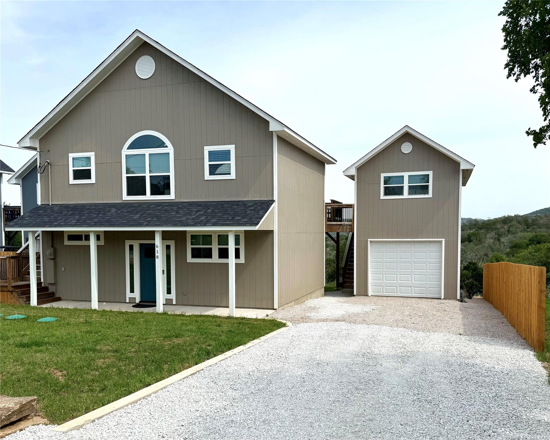 View of front of home featuring driveway, covered