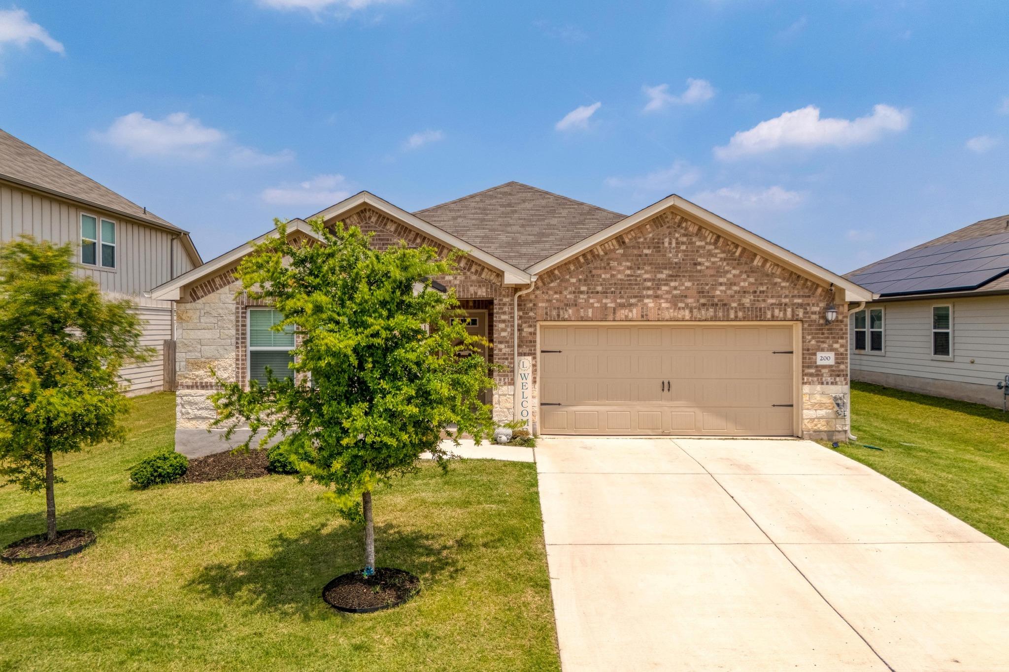 View of front facade featuring a garage, a front 