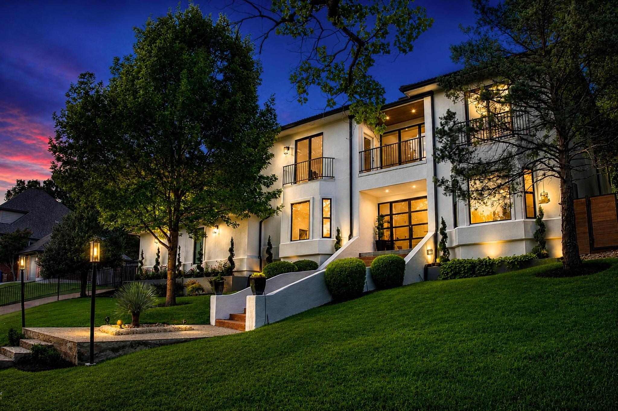 Illuminated at dusk, this contemporary residence 