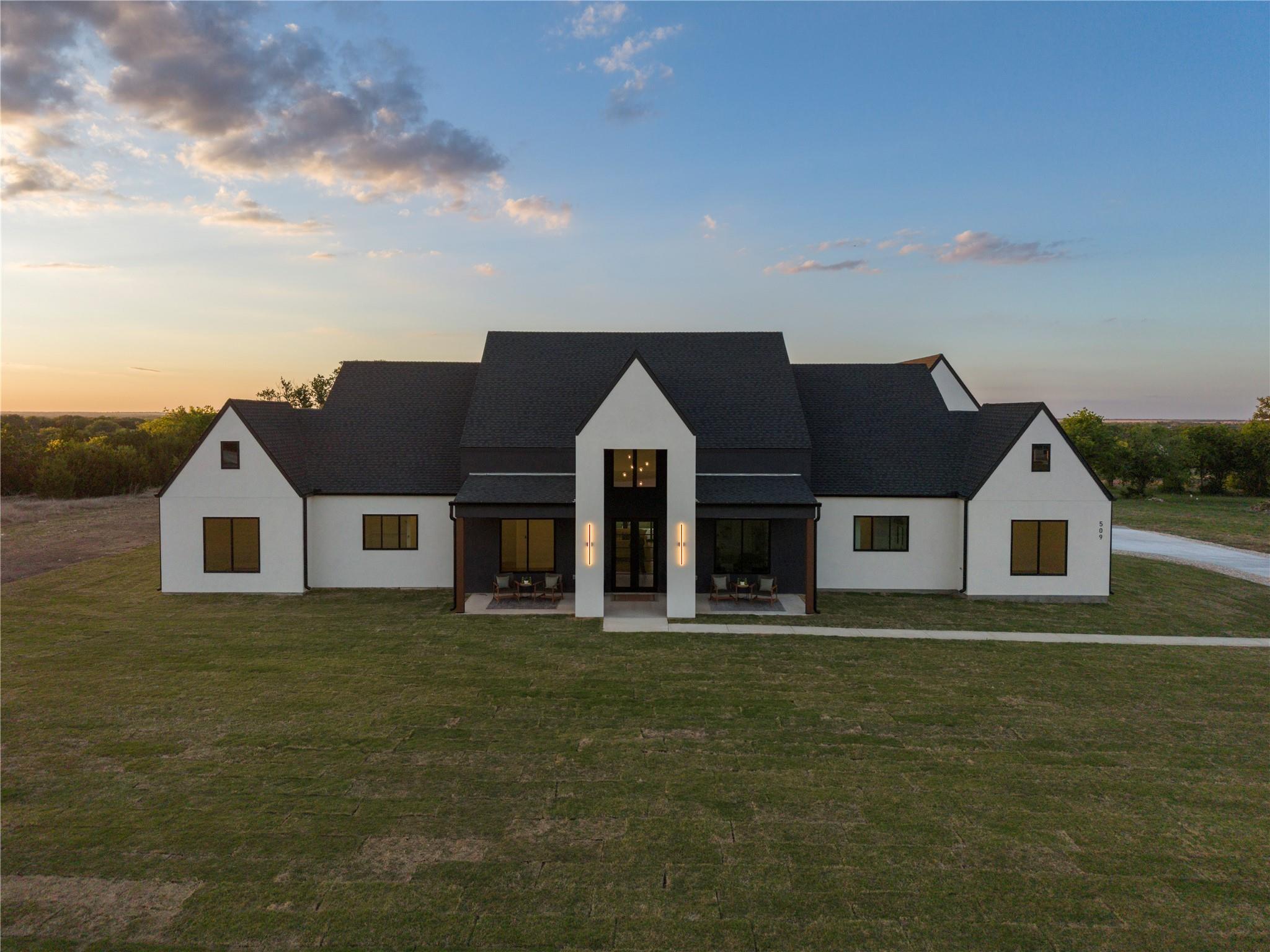 Modern farmhouse style home with a porch and a ya