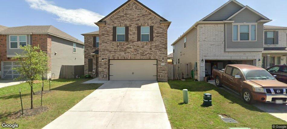 Traditional home with concrete driveway, brick si