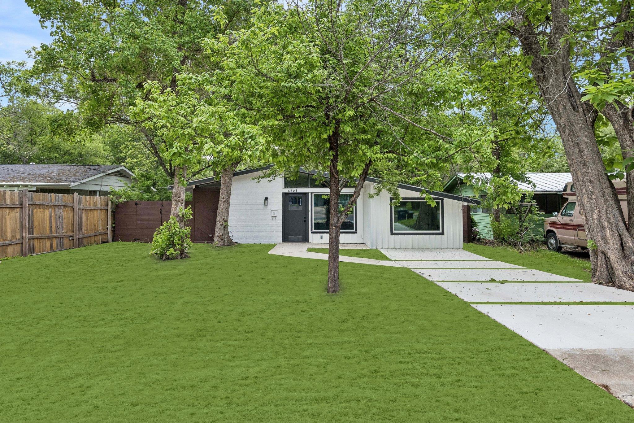 Modern ranch-style residence featuring a white pa