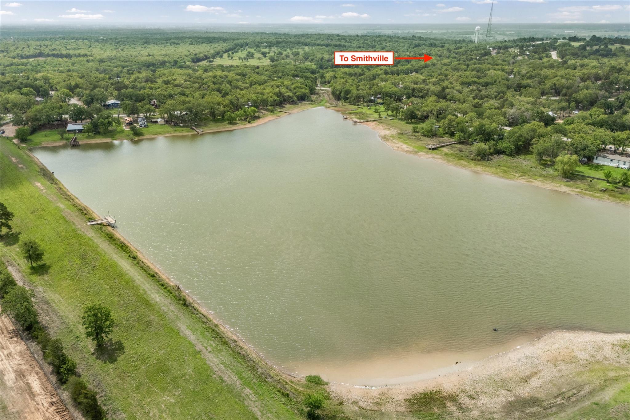 Aerial view of a lake with surrounding green area