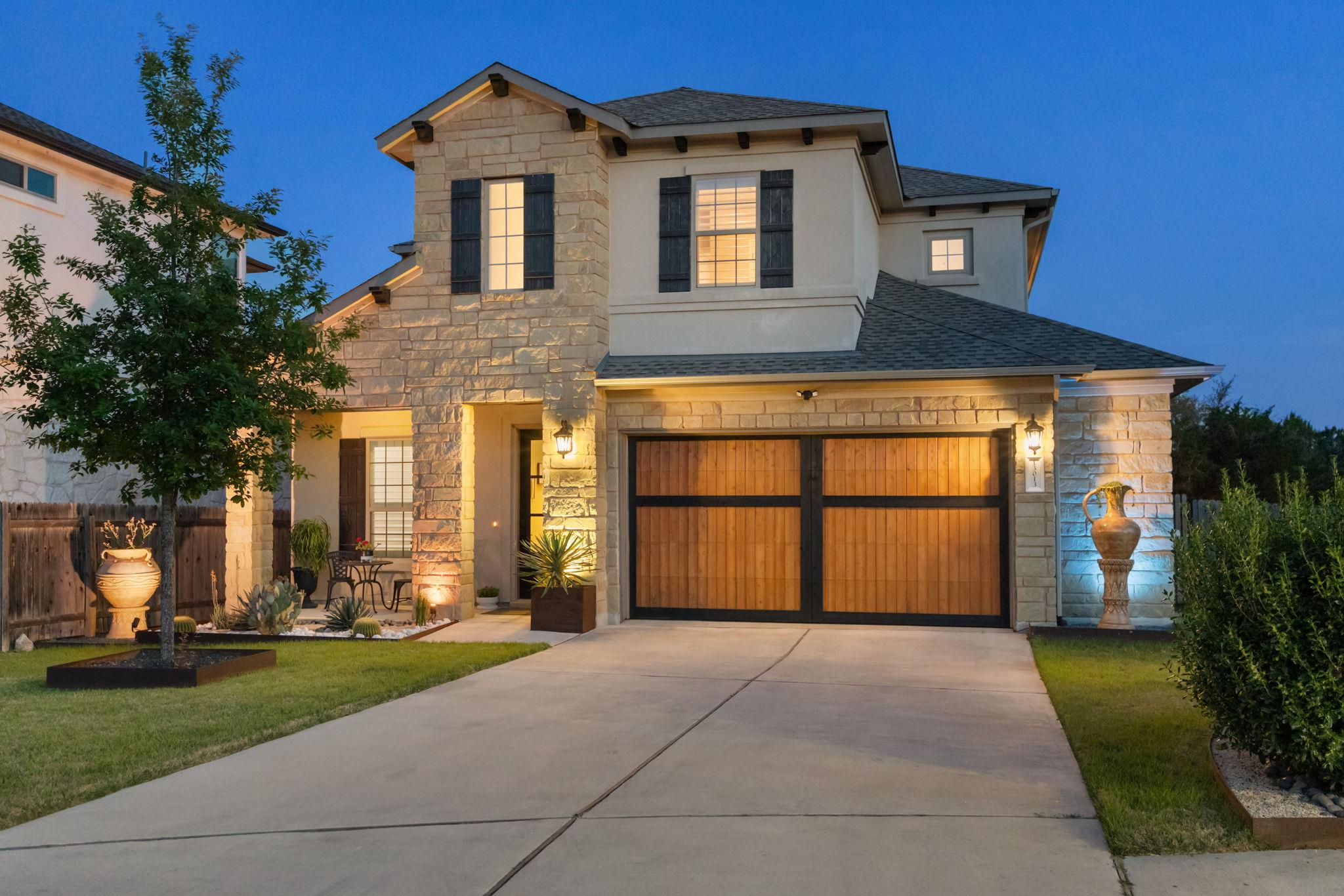 View of front of home with stone siding, concrete