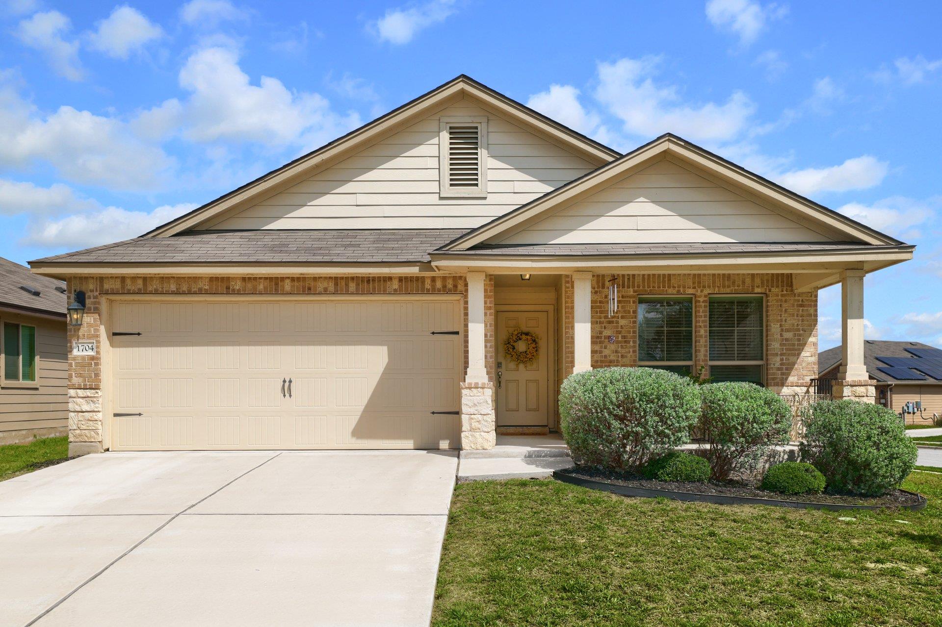 View of front of property featuring driveway, a g