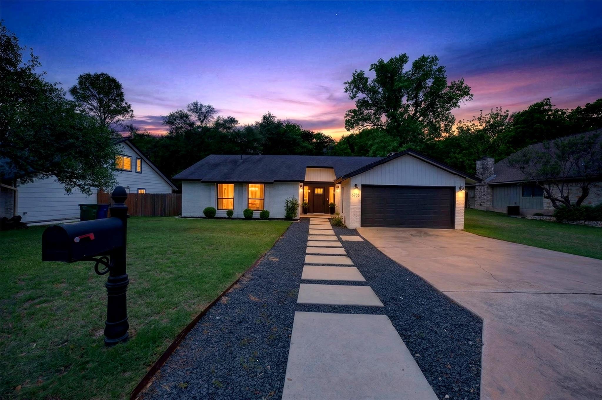 View of front of house with driveway and a garage