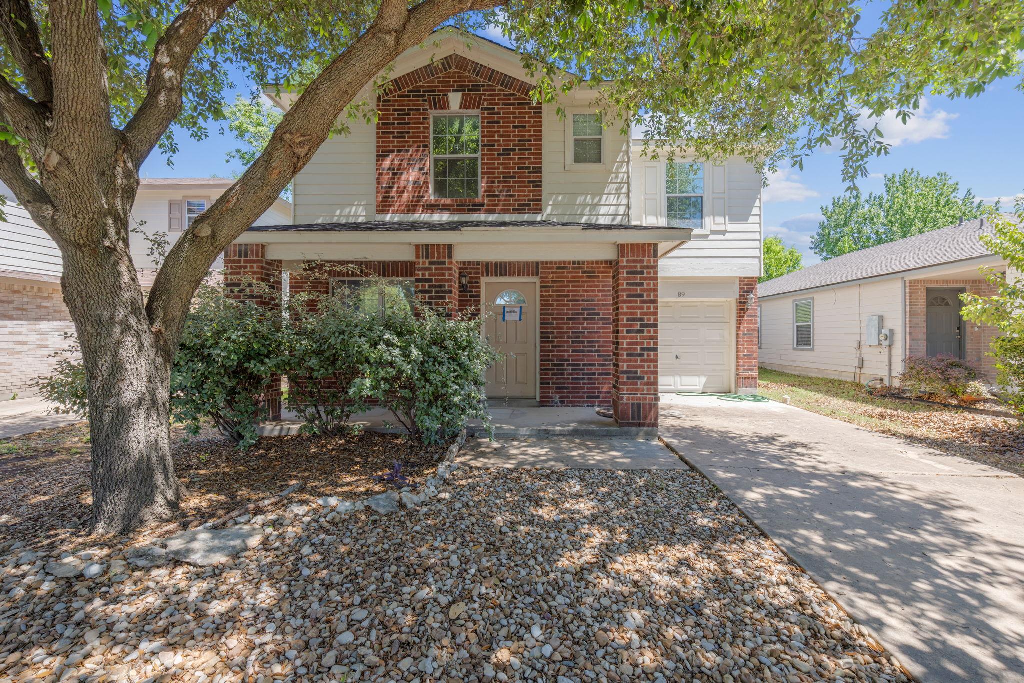 Traditional-style home with brick siding, concret