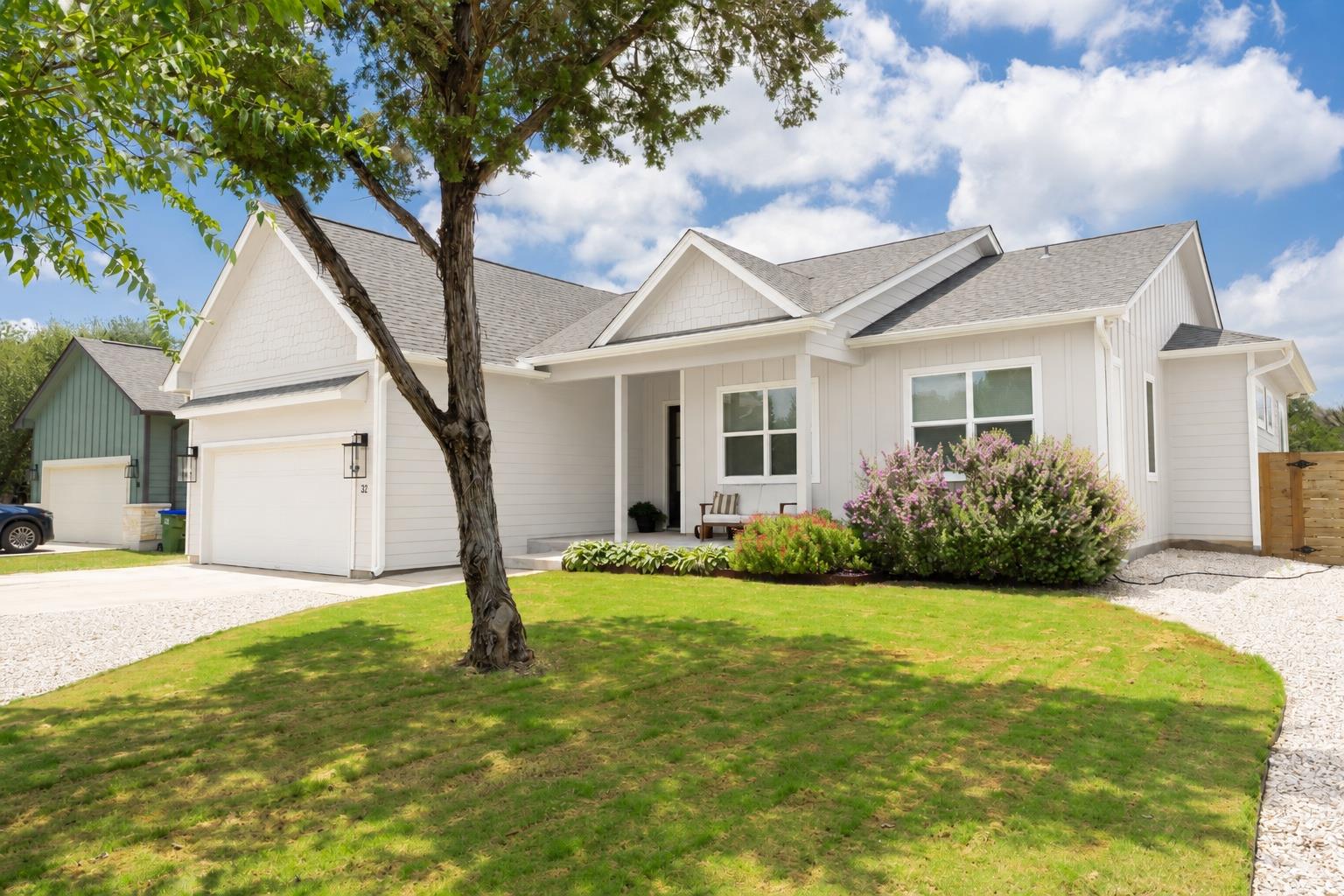 Crisp white siding and architectural gables defin