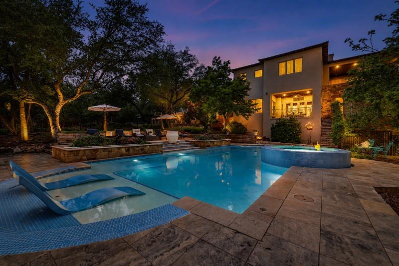 An inviting backyard oasis offers a sparkling poo
