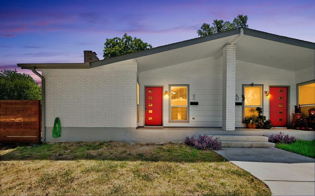 View of front of home featuring a porch, brick si