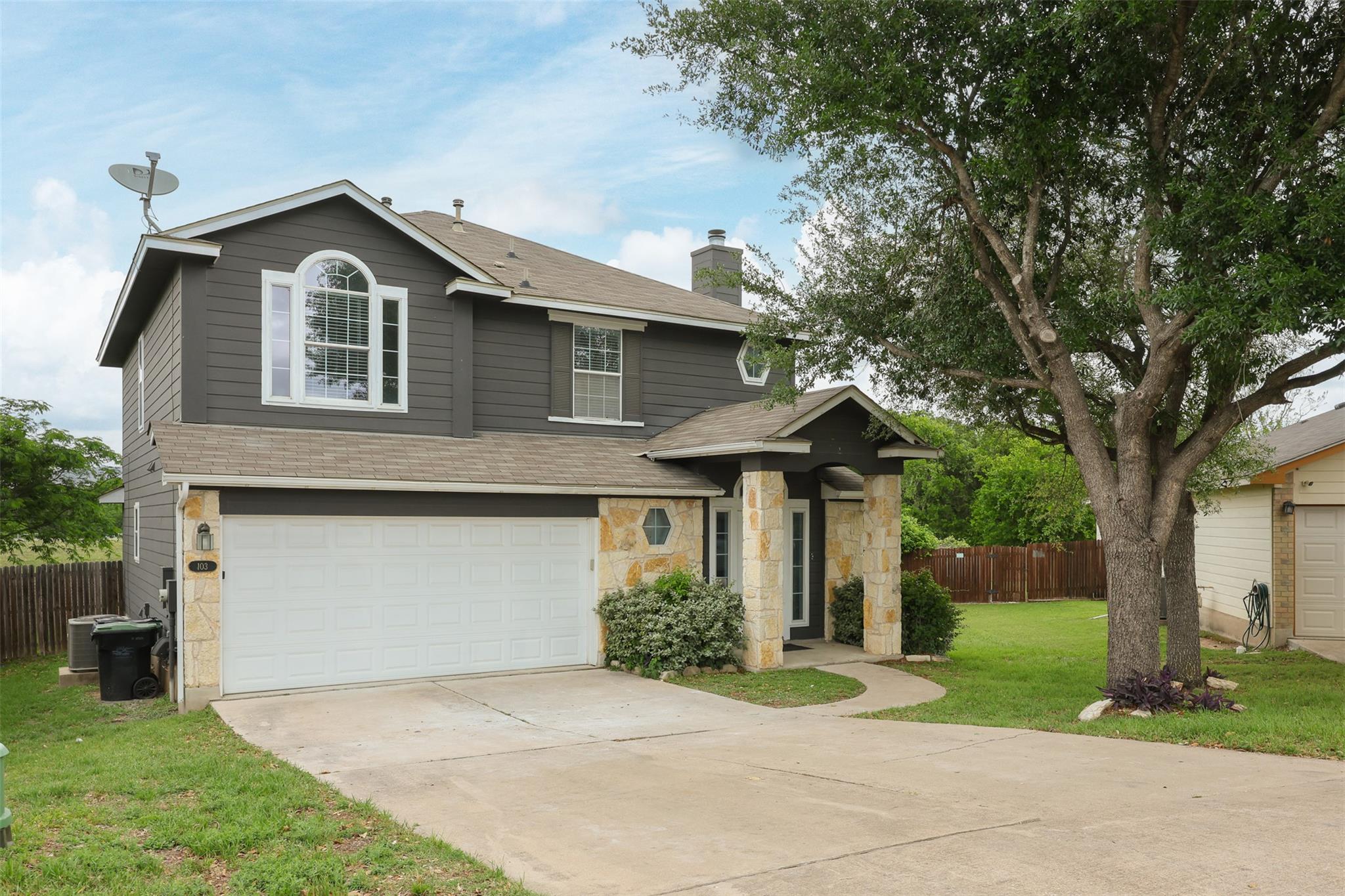 Traditional-style house featuring a shingled roof