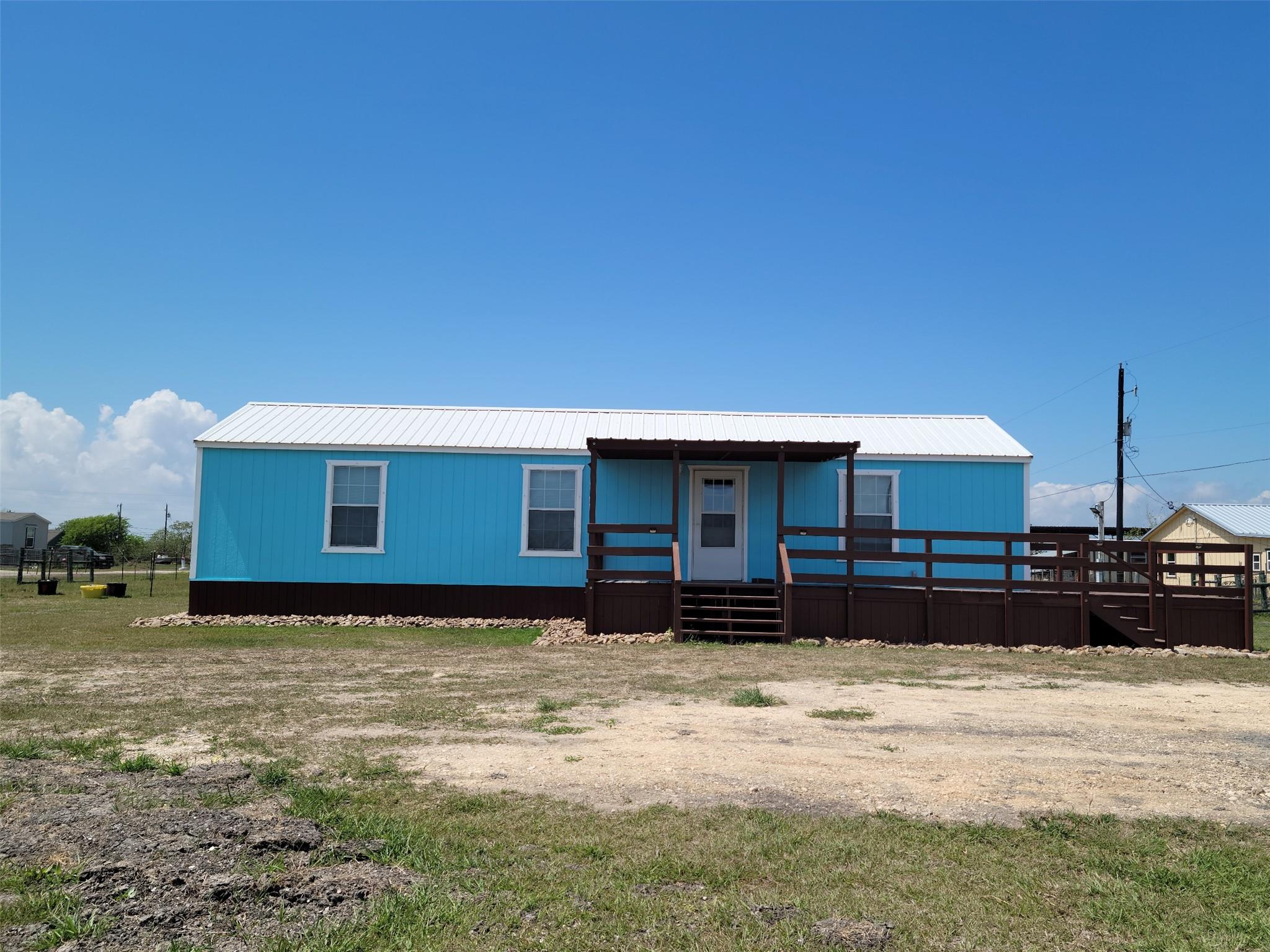 View of front of property with a metal roof and c