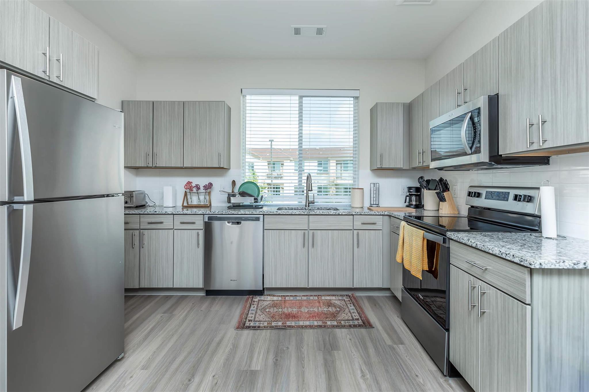 Kitchen with stainless steel appliances, light st