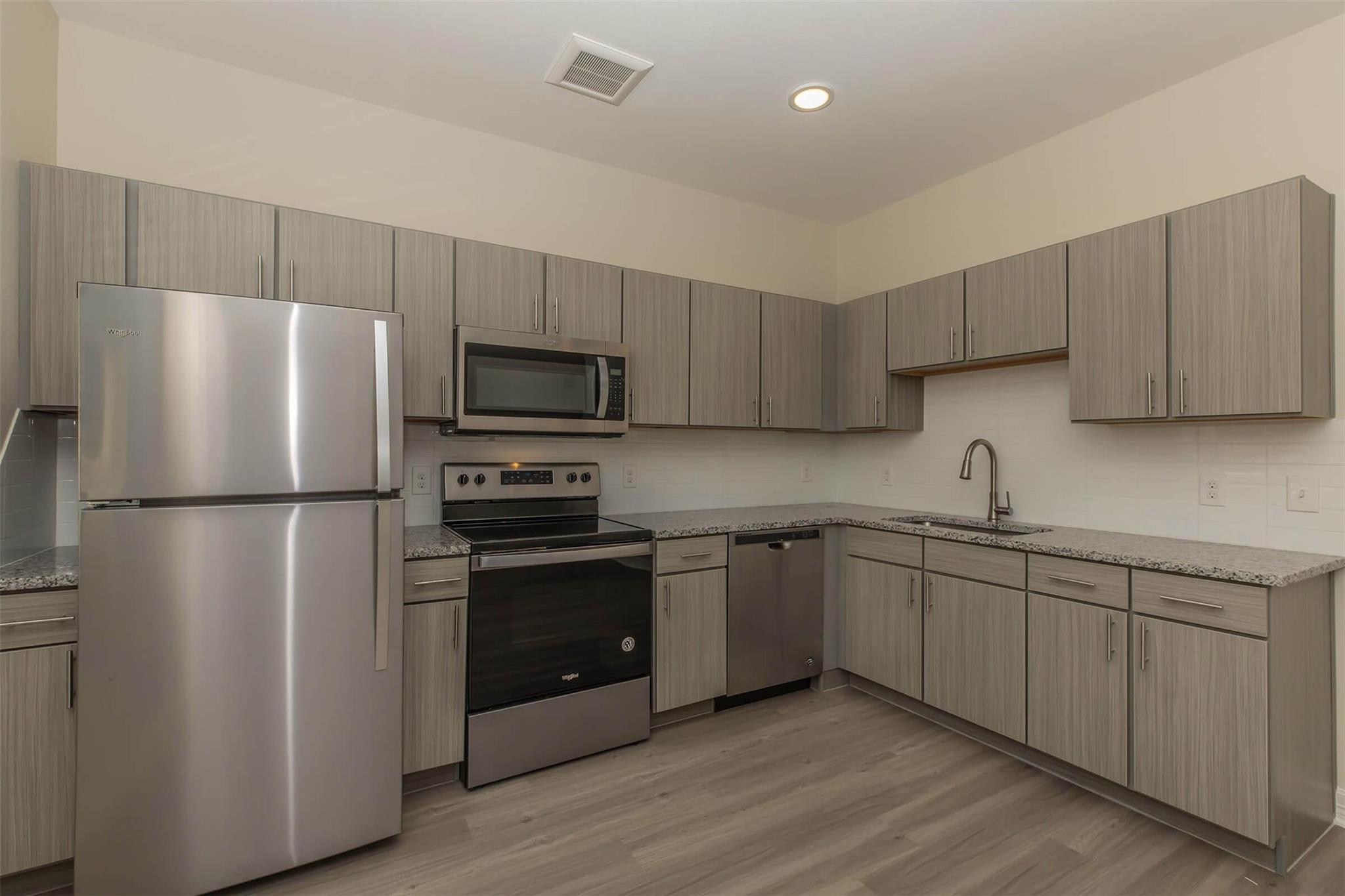 Kitchen with stainless steel appliances, light st