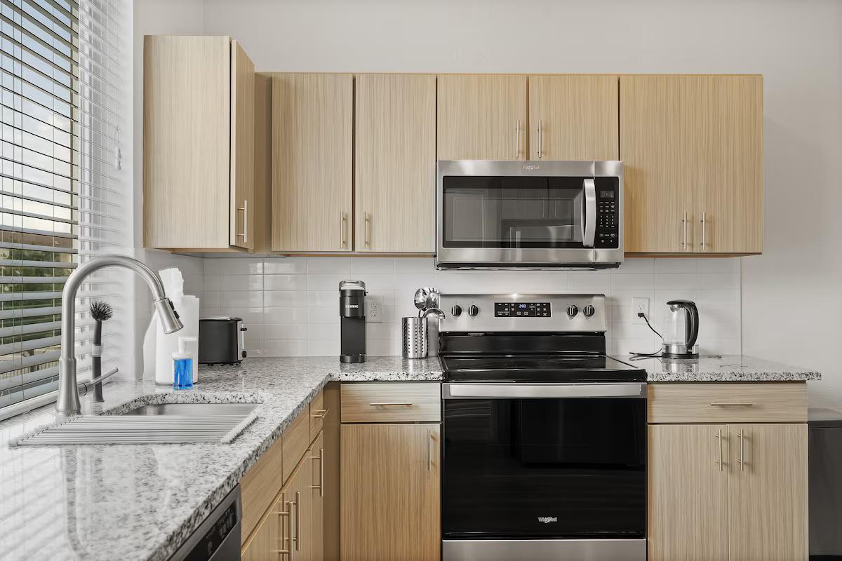 Kitchen with stainless steel appliances, light st