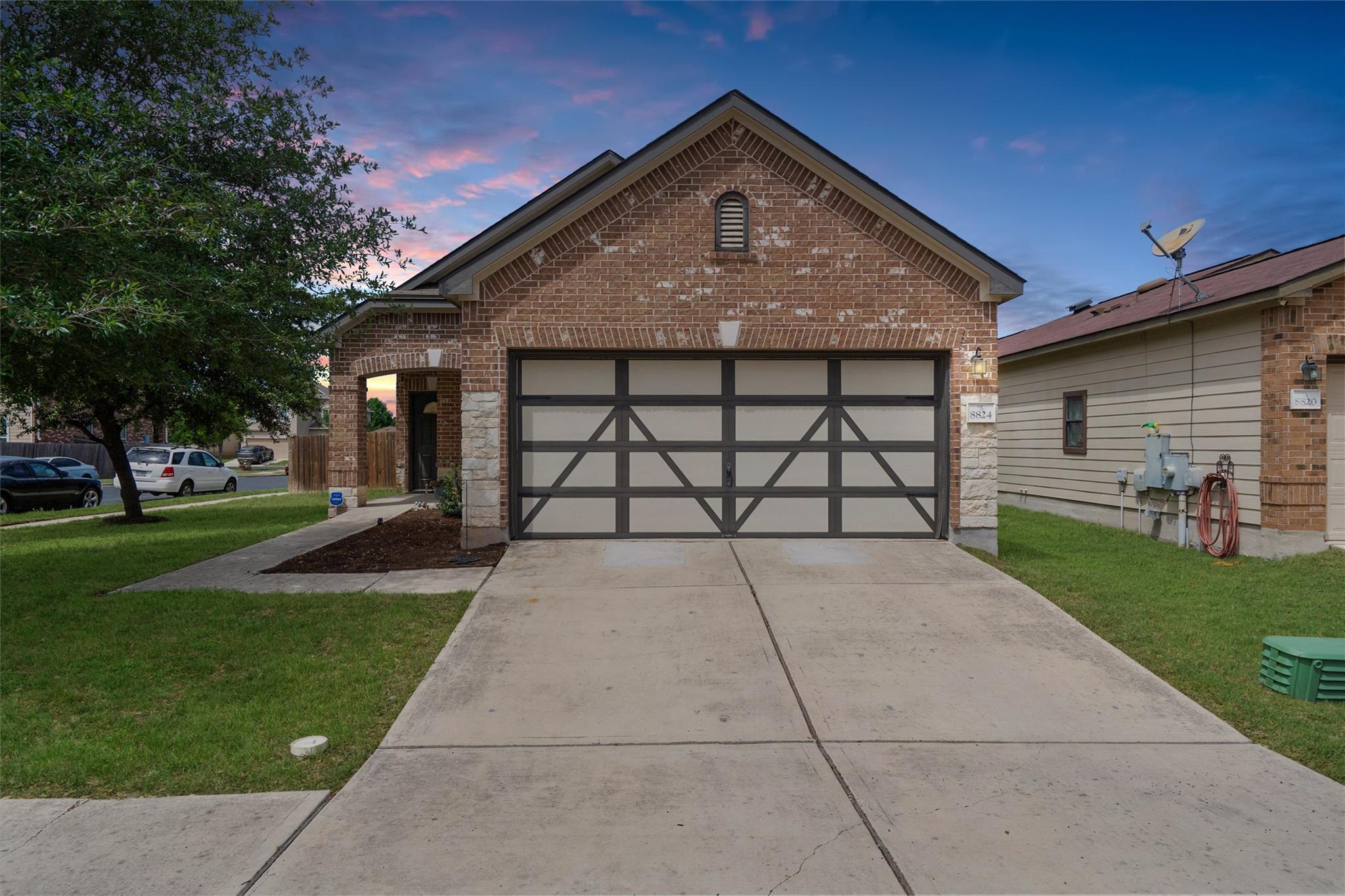 View of front of home featuring brick siding, a f