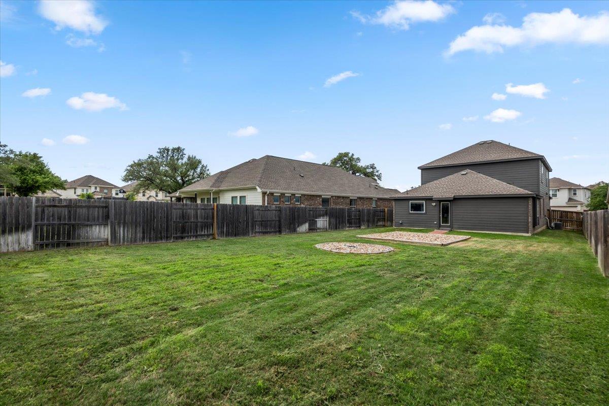 The property features a spacious backyard with a 