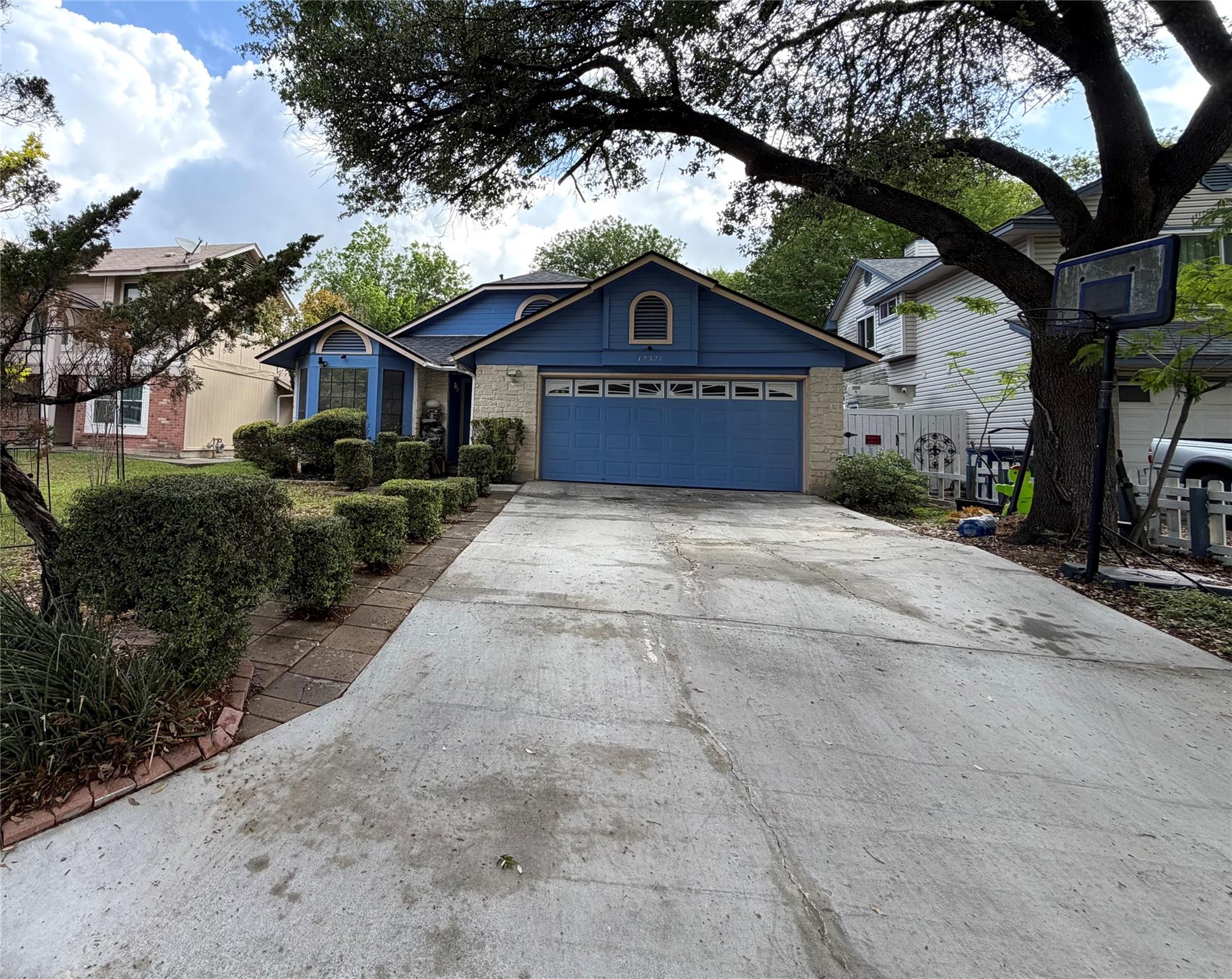 The property features a concrete driveway leading