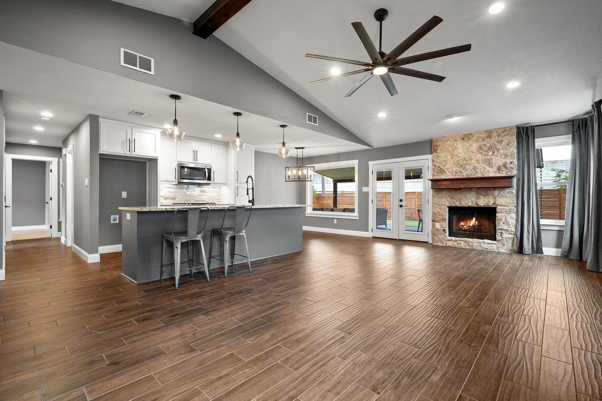 Kitchen with open floor plan, hanging lights, woo