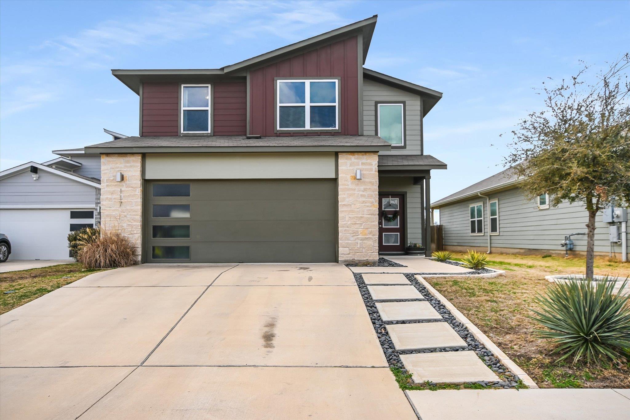 Contemporary home with stone siding, board and ba