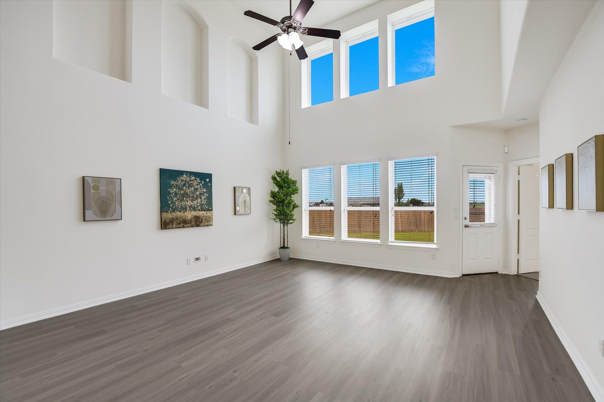 Living area featuring high ceilings, gray plank f