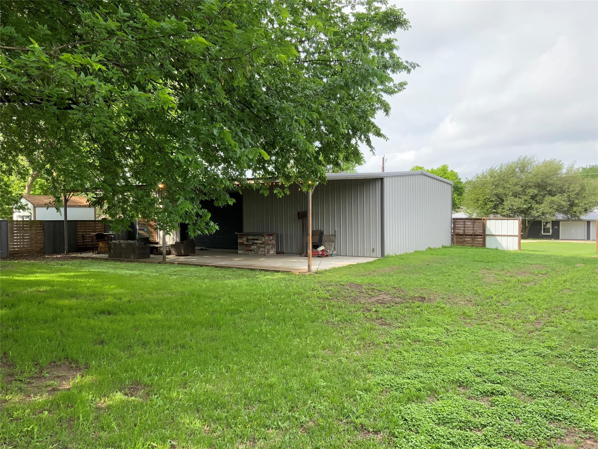 The property features a spacious yard with a lush