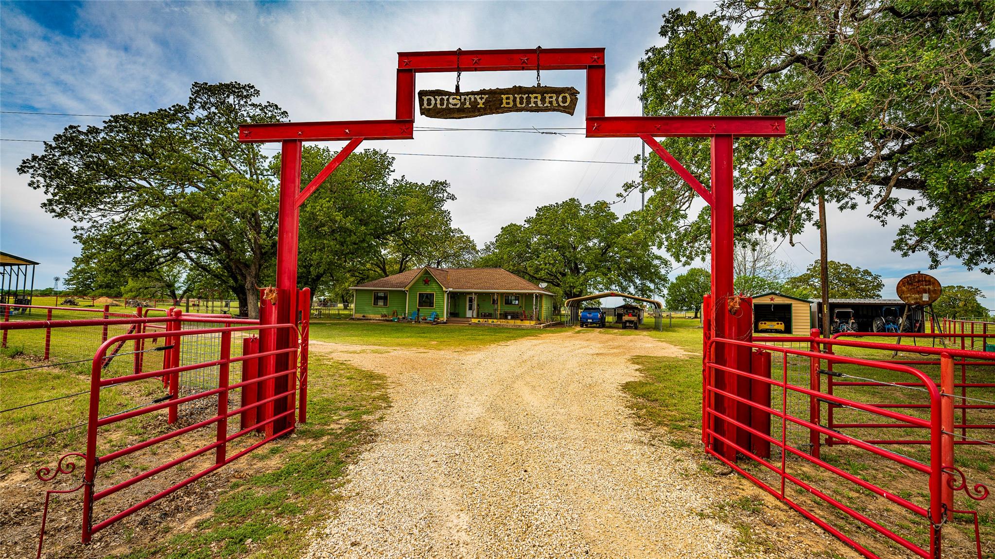 View of dirt / gravel road with a gated entry