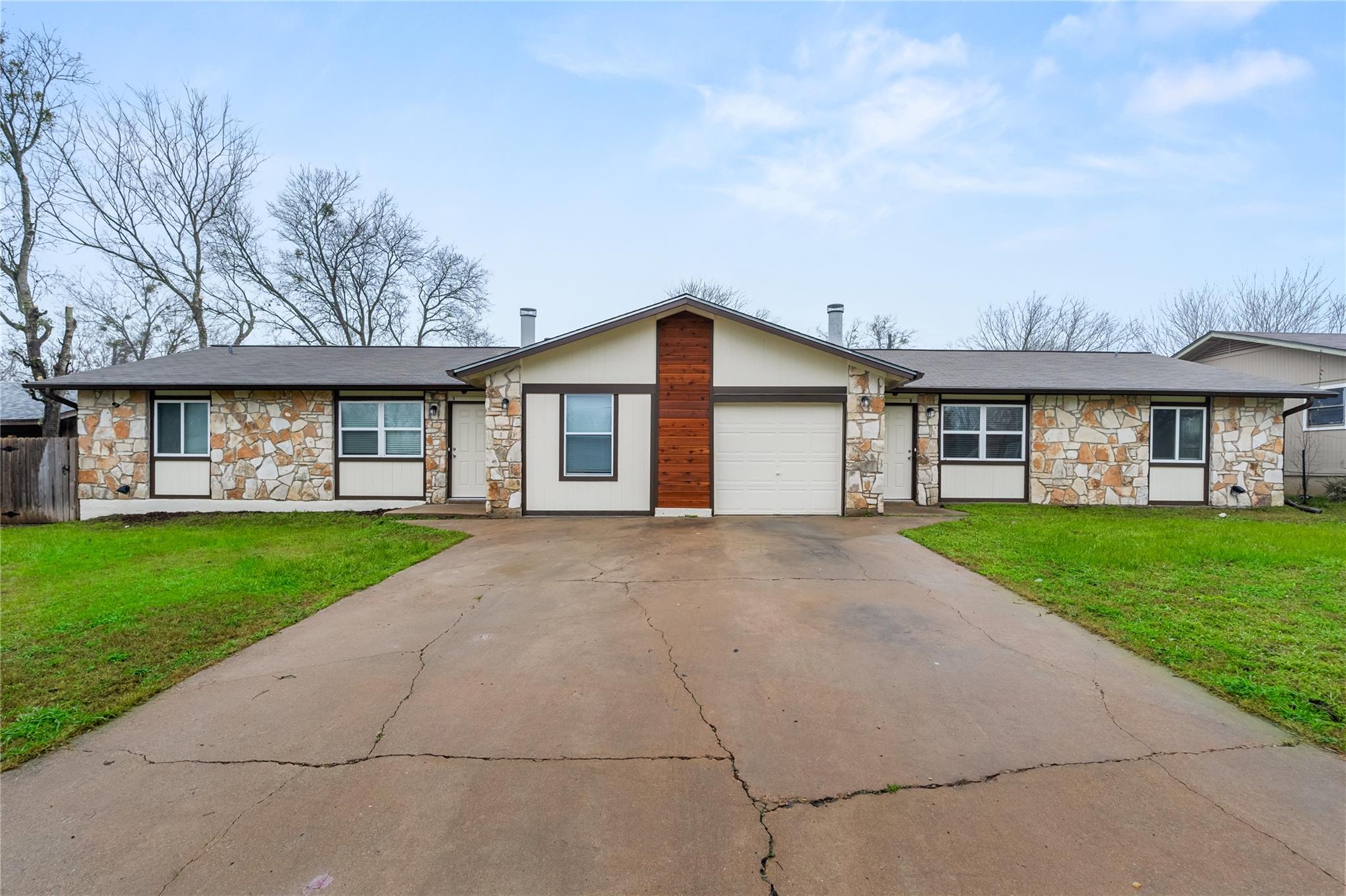 View of front facade featuring stone siding, conc