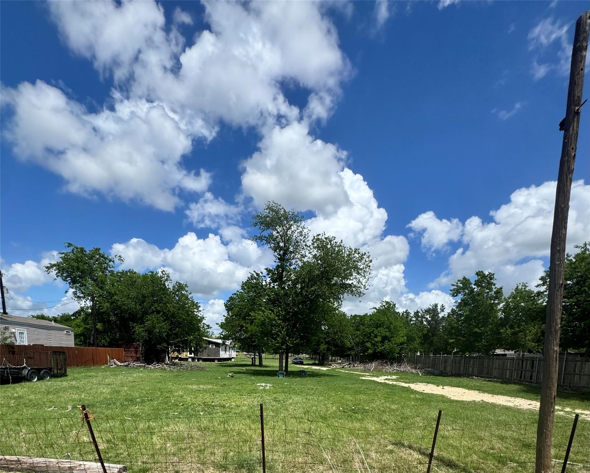The property features an expansive grassy area wi
