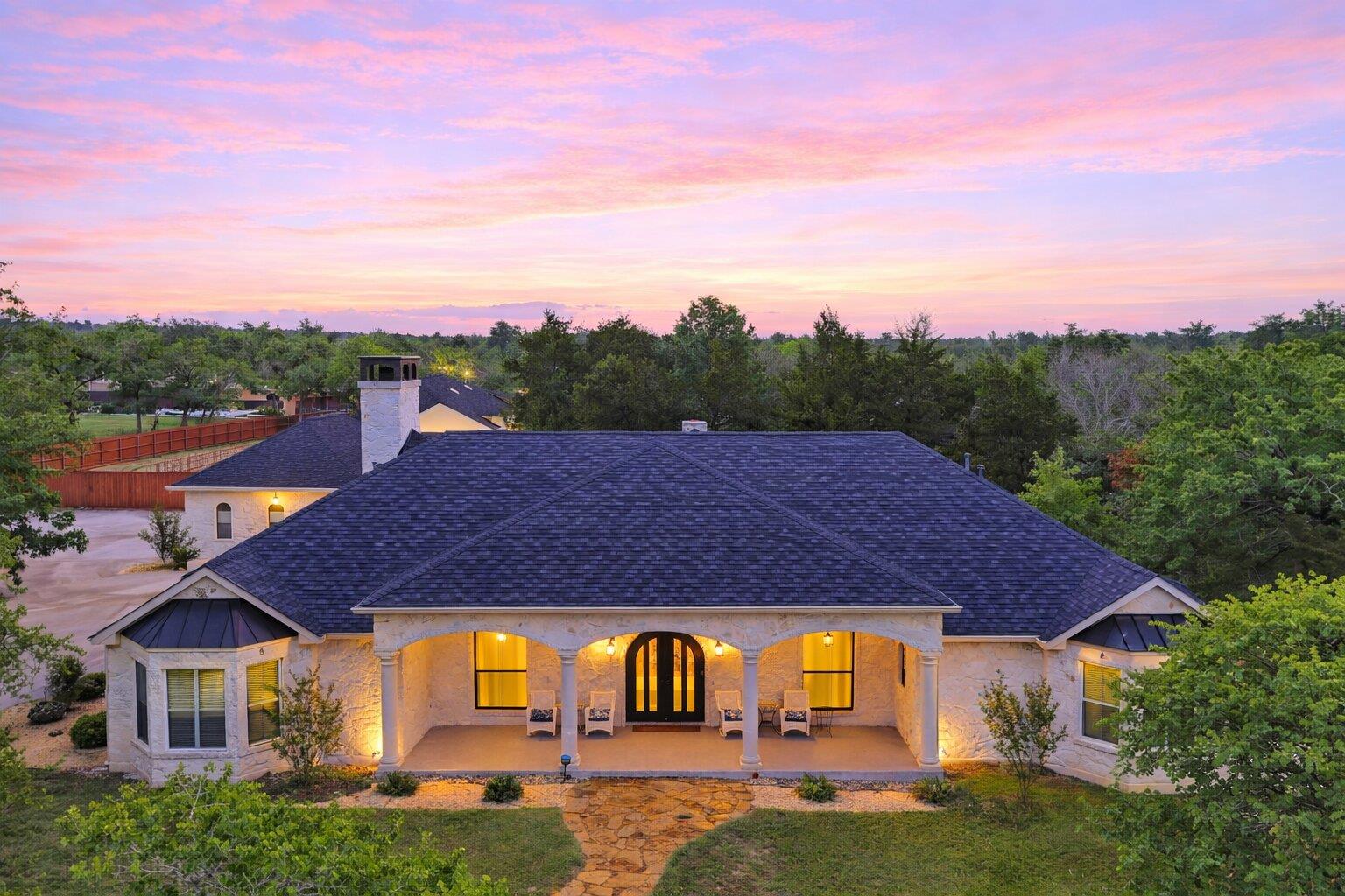 The property features a stone exterior, a dark sh