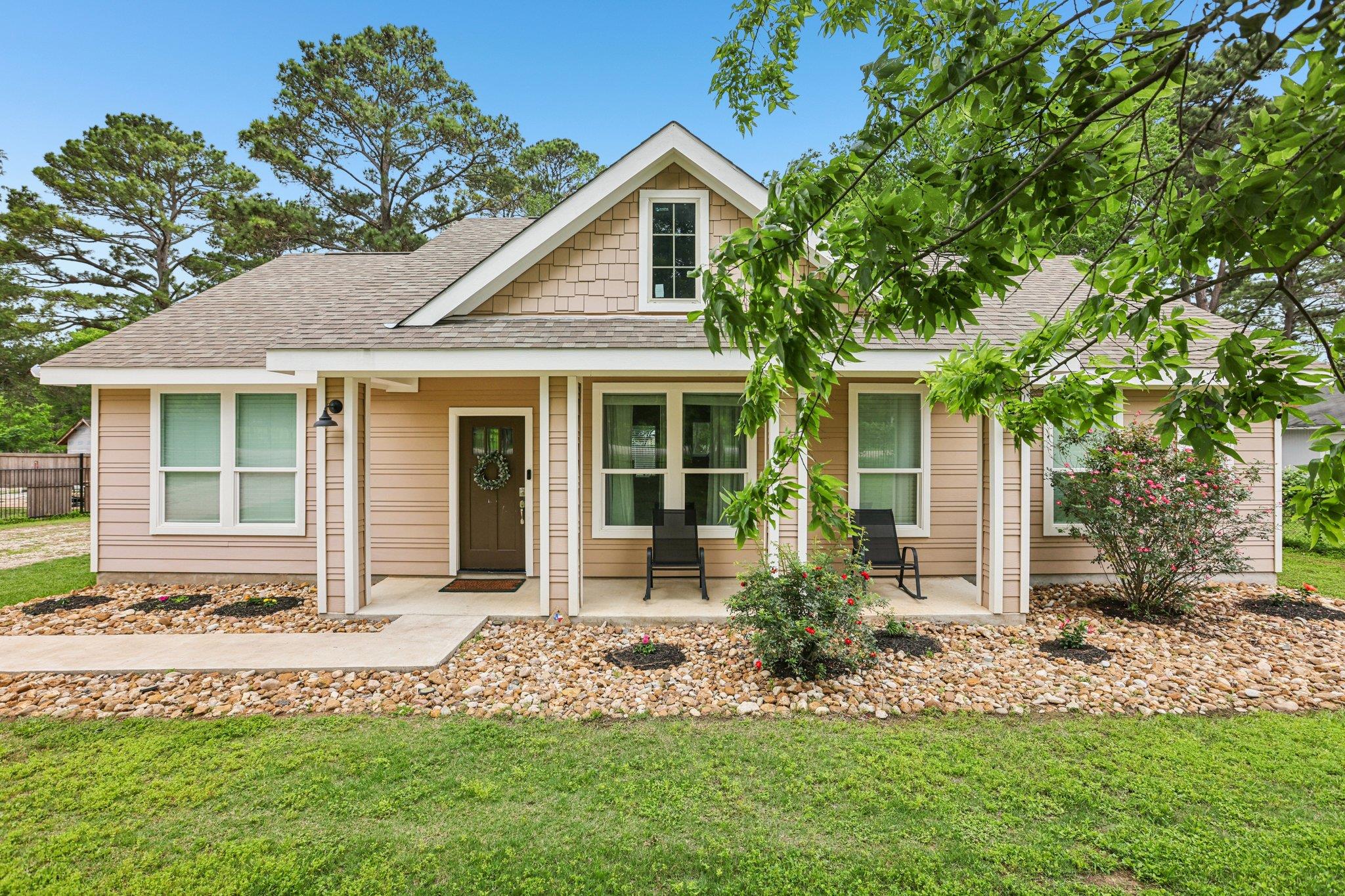 The property features a welcoming front porch wit
