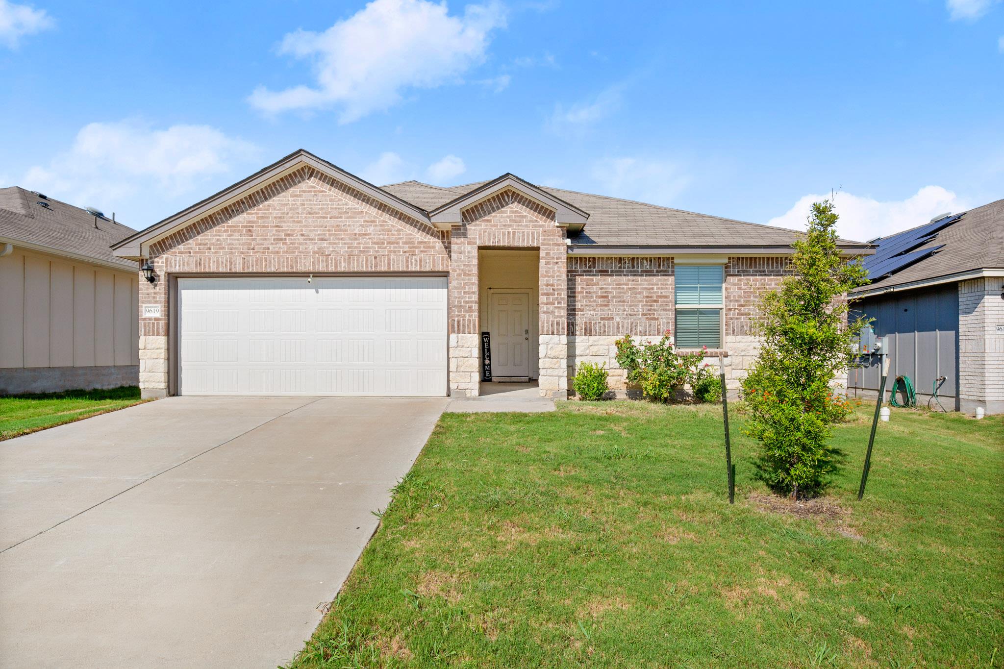 The property features a brick and stone facade, a