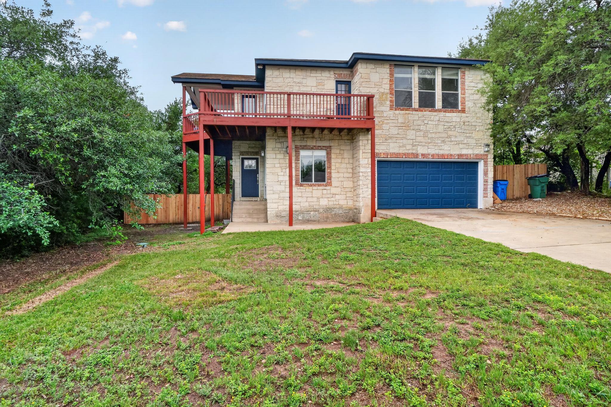 The property features a stone exterior, a two-car