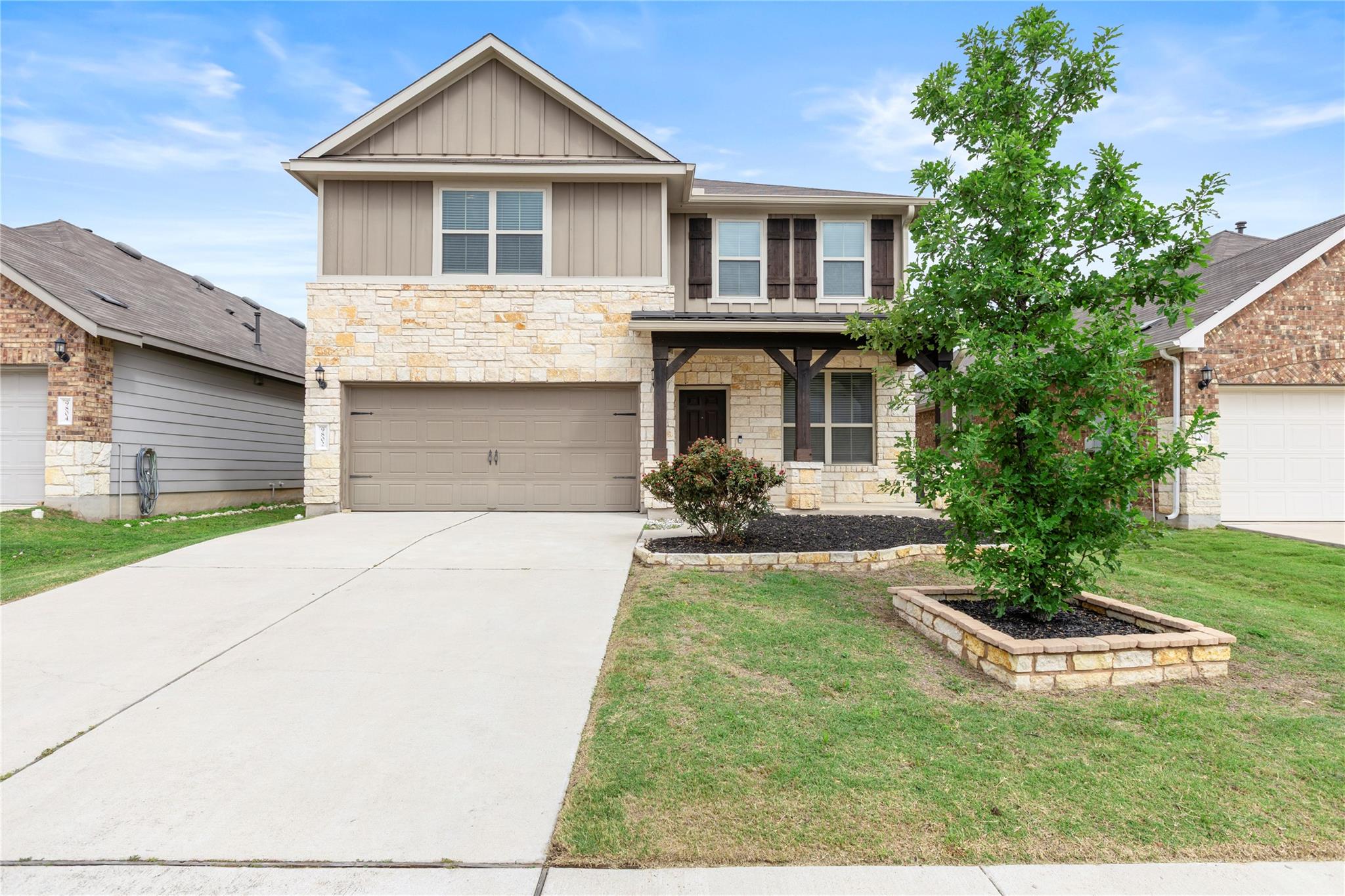A classic two-story exterior showcases stone vene