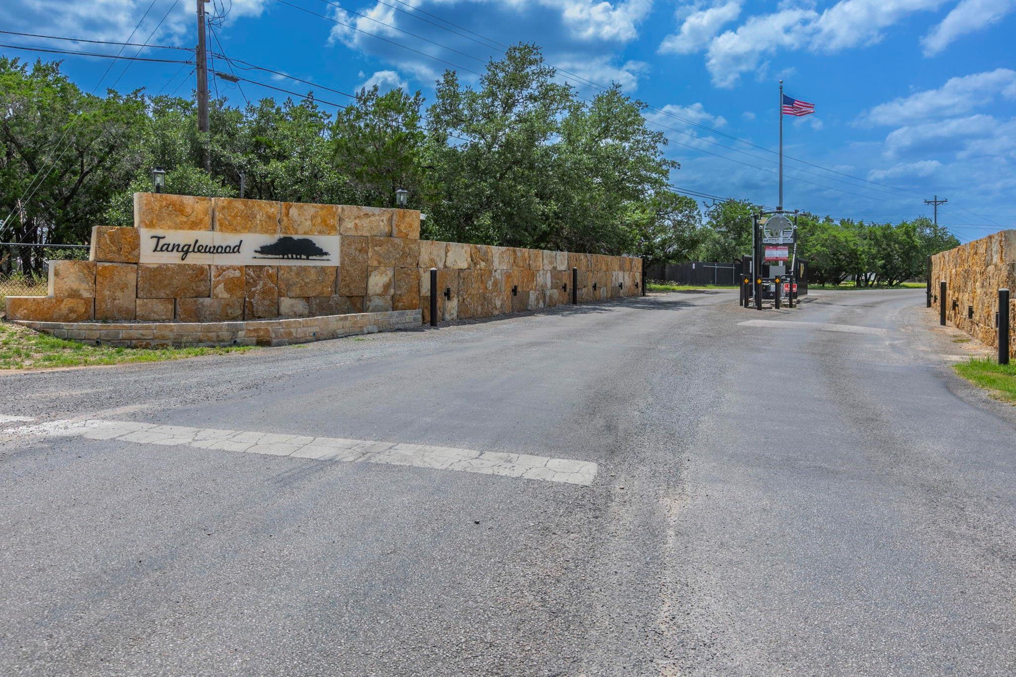 The property entrance features a stone wall with 